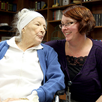 Woman and an elderly woman looking at each other. Beaver Dam Community Hospital home care